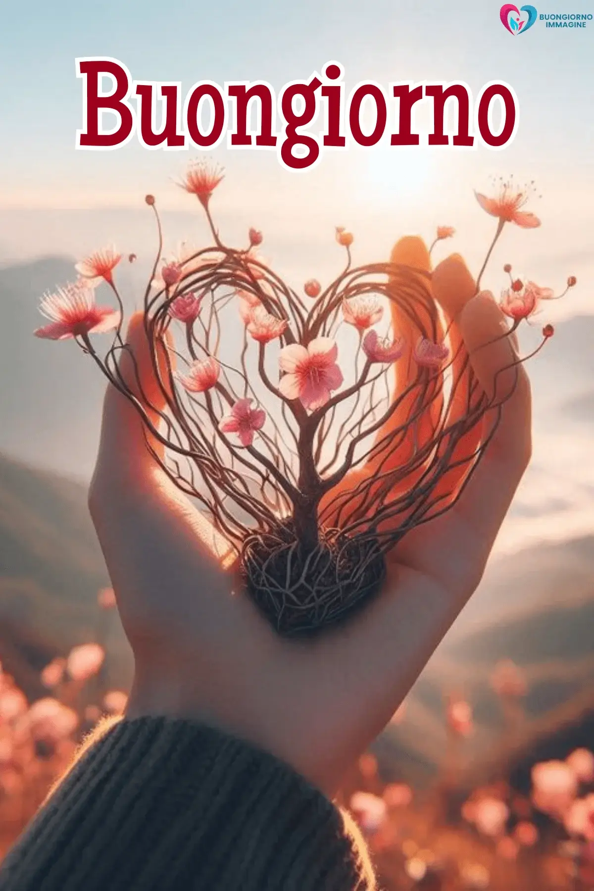 Mano che regge un albero a forma di cuore con fiori rosa – buongiorno cuore immagini gratis per WhatsApp